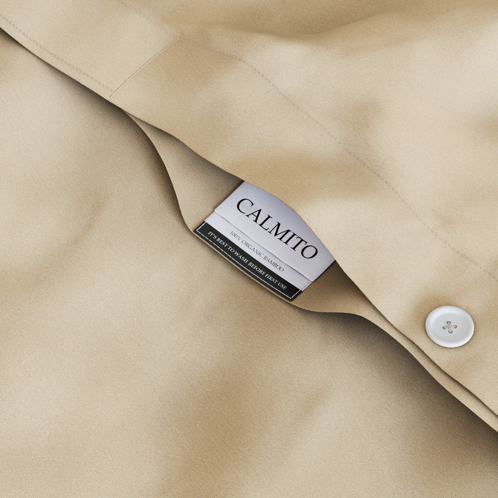 Close-up of beige fabric with a Calmito label and button