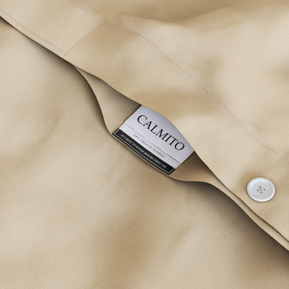 Close-up of beige fabric with a Calmito label and button