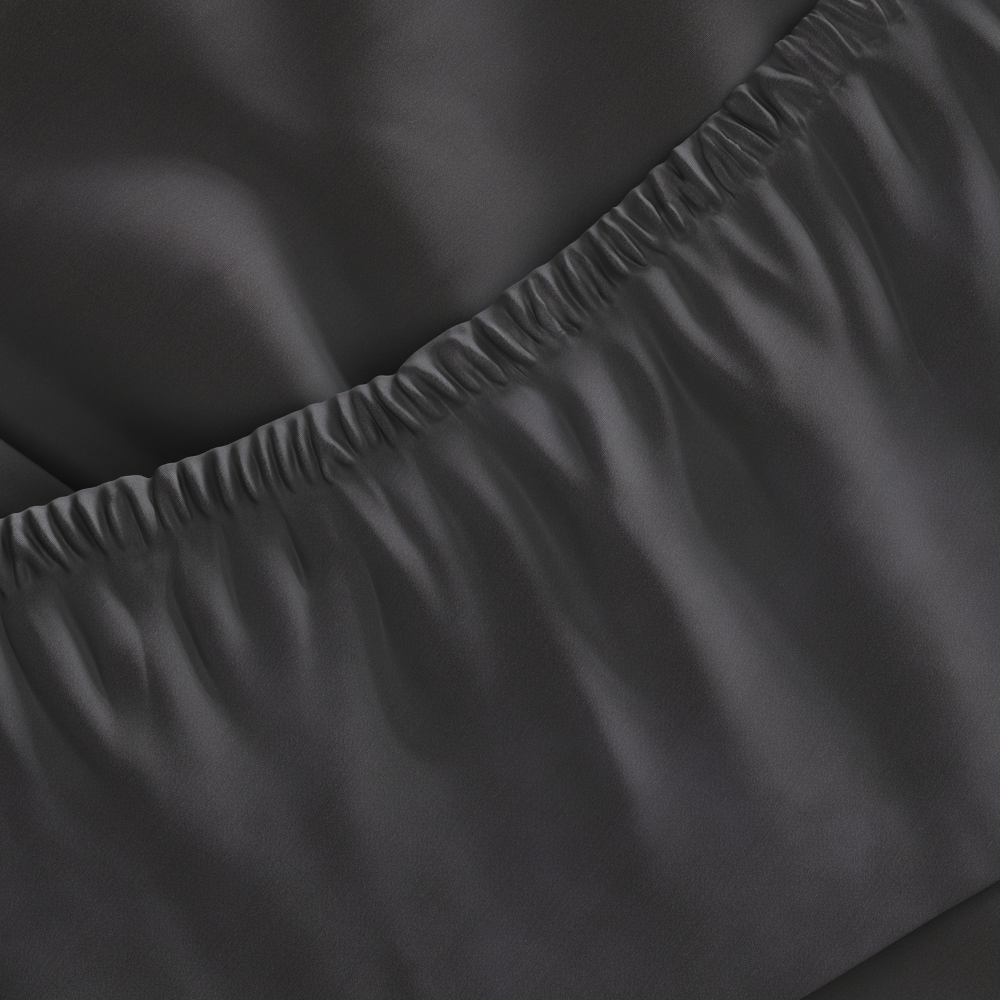 Close-up of dark gray fitted sheet with a slight wrinkle on a surface.